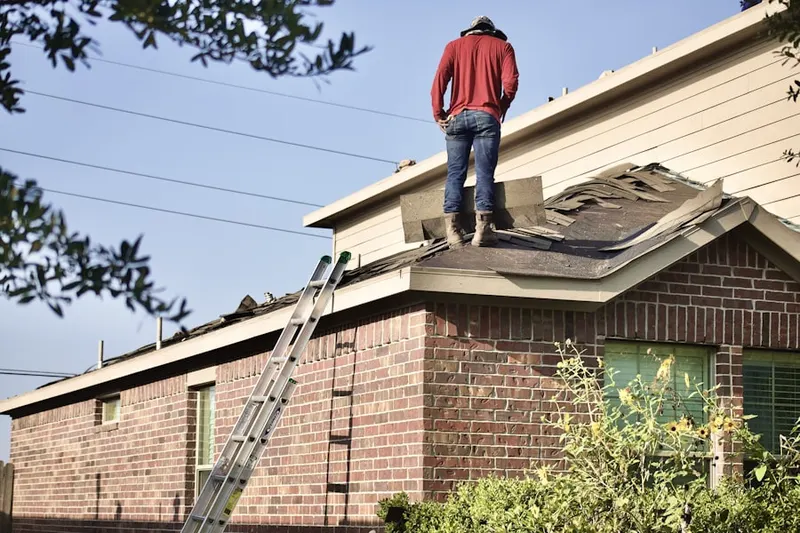 Professional roofer working on a residential roof in Rancocas Woods